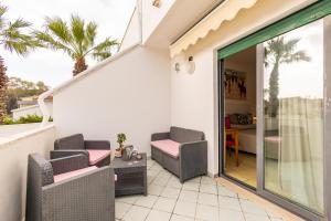 a patio with two chairs and a table at Hotel Paistos Paestum in Paestum