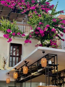 a building with pink flowers hanging from it at Kalkan Port Hotel in Kalkan