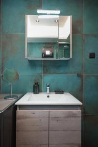 un baño con lavabo y espejo en Rene Luxury Apartment, en Zakynthos