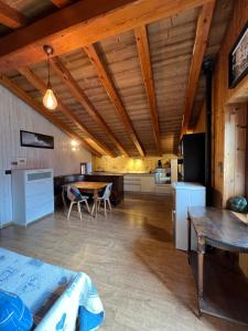 a room with a bed and a table and a kitchen at casa del sole in Saint-Pierre