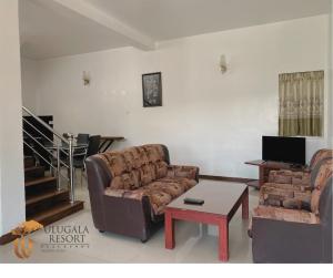a living room with a couch and a coffee table at Ulugala Resort in Nuwara Eliya