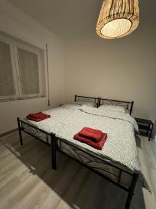 a bedroom with a bed with two red towels on it at Lavanda House in Vicenza