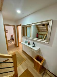 a bathroom with a sink and a mirror on the wall at CASA do AÇÔR in Aldeia das Dez