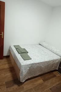 a bed sitting in a room next to a wall at Apartamento Puente Romano in Salamanca