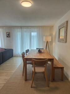 a dining room table and chairs in a living room at Casa LeYu mitten in Ruschein in Ruschein