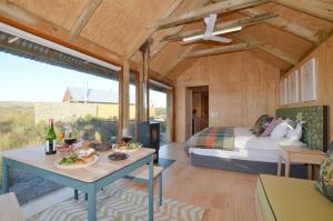 a bedroom with a bed and a table with food on it at !Khwa ttu in Swartwater