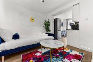 a living room with a bed and a table at Gorgeous Home in Islington in London