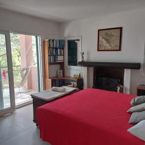 a bedroom with a large bed with a red blanket at Holiday Lodge M3 in Žirje