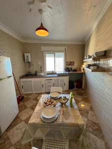 a kitchen with a table with plates on it at Dar Saphire Apartments in Chefchaouen