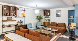 a living room with a couch and a table at Best Western Plus Hotel Cargo in Dunkerque