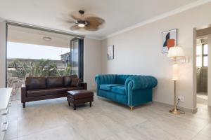 a living room with a couch and a chair at Shanthi Apartment 2 in Ballito