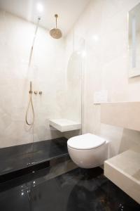 a white bathroom with a toilet and a shower at Luxury Flat - Opera & Upper Marais in Paris