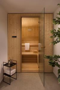 a bathroom with a sauna with a glass door at Luxury & Unique Villa Bevel House with sea view in Orebić