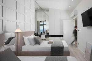 a bedroom with a bed and a living room at Luxury & Unique Villa Bevel House with sea view in Orebić +26 photos