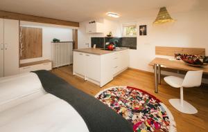 a bedroom with a bed and a kitchen with a table at Villa Marwa - eine Ruheoase im Grünen in Innsbruck +43 photos