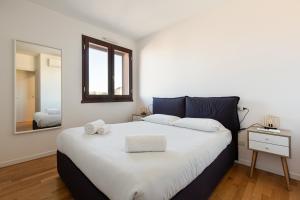 a bedroom with a large bed and a mirror at Sweet Milano Apartment - with Balcony in Milan