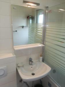 a white bathroom with a sink and a shower at Eli's luxury apartment in Zagreb