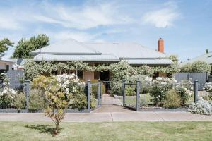 a house with a fence in front of it at Dunrobin House in Shepparton