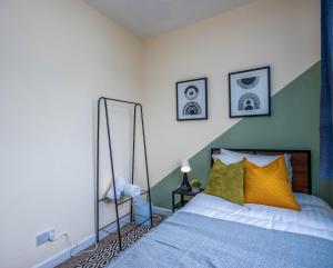 a bedroom with a bed with two mirrors on the wall at 4 Bed House With Driveway Parking in Southampton