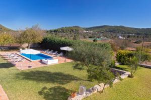 an external view of a garden with a swimming pool at Villa in San Jose sleeps 10 - Sa Vinya in Sant Josep de Sa Talaia