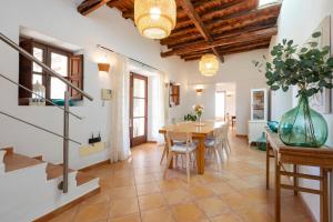 a kitchen and dining room with a table and chairs at Villa in San Jose sleeps 10 - Sa Vinya in Sant Josep de Sa Talaia