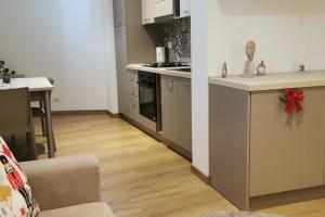a kitchen with a sink and a stove top oven at Modern renovated apt in center in Scicli