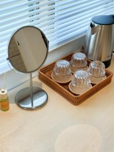 a tray of glass domes and a mirror on a counter at Heritage Vacation Inn Balcony in Kuching