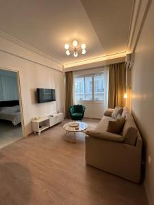 a living room with a couch and a table at Syntagma Hideaway Luxury Apt in Athens