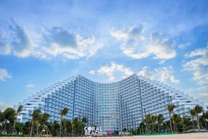 um grande edifício branco na praia com palmeiras em Seaview Cam Ranh Beach Resort Nha Trang Near The Airport Best Location em Cam Ranh