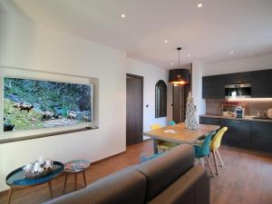 a living room with a couch and a table at Gîte Alsacien : Terrasse, Sauna Privé, Accès Piscine et Bien-être, Proche Colmar et Route des Vins - FR-1-744-16 in Rouffach
