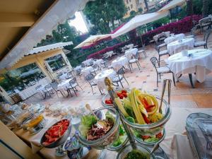 a table with bowls of food on top at Hotel Metropole in Santa Margherita Ligure