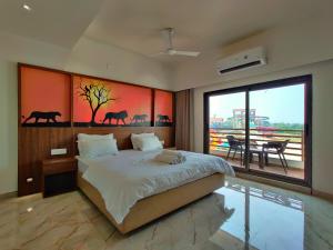 a bedroom with a large bed and a large window at Wet n wild water park & resort in Mendarda