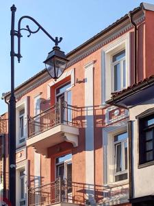 a building with balconies and a street light at Melina Hotel - Central in Poligiros