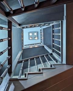 a staircase in a room with blue walls at Melina Hotel - Central in Polygryos