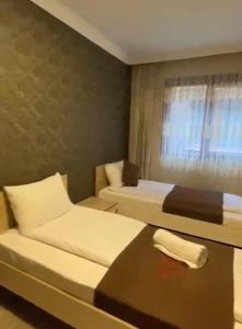 ウズンギョルにあるAygün Suites Hotel&Bungalow UZUNGÖLのベッド2台とテーブルが備わるホテルルームです。