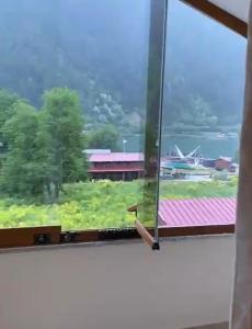 a window with a view of a field at Aygün Suites Hotel&Bungalow UZUNGÖL in Uzungöl