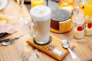 a drink pitcher on a wooden table with a spoon at Pension Linder in Seeboden +46 photos