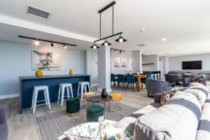 a living room with a couch and a bar at *One On Albert 511*Studio Apartment - Swimming Pool, WI-FI & Netflix* in Cape Town