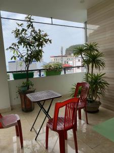 a table and chairs on a balcony with plants at Galaxy Home - Hotel Sky view in Cat Ba +29 photos