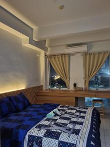 a bedroom with a bed and a window at Capital O 93490 Yubi Room Patraland in Bekasi