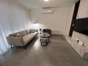 a living room with a couch and a table at Johnny's luxury getaway in Strovolos