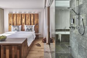 a bedroom with a bed and a shower at Falkensteiner Hotel & Spa Carinzia in Tröpolach