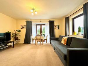 a living room with a couch and a table at Super Apartment next to Bicester Village Sleeps 4 in Bicester