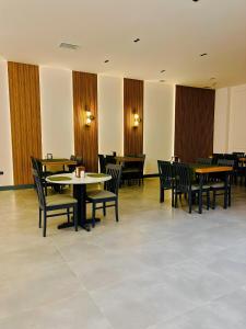 a dining room with tables and chairs and tables and chairs at Grand Keskin Otel in Denizli