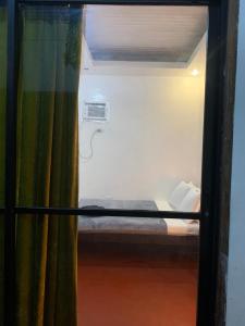 a room with a bunk bed with a window at Dadods homestay in General Luna