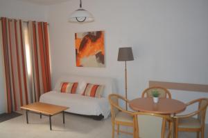 a bedroom with a bed and a table and a table and chairs at Villa Lyss Apartment 1 in Mellieħa +24 photos