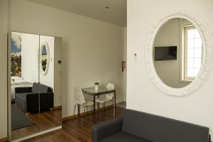 a living room with a couch and a mirror at Clerigos View in Porto