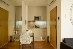 a kitchen with a table and chairs in a room at Clerigos View in Porto