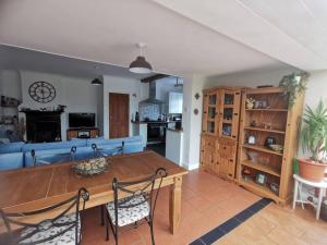 a living room with a table and a blue couch at Sunny Family Residence with parking. Jacuzzi bath perfect for relaxing and unwinding in Kent