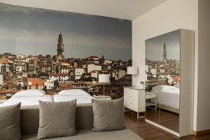 a bedroom with two beds and a view of a city at Clerigos View in Porto